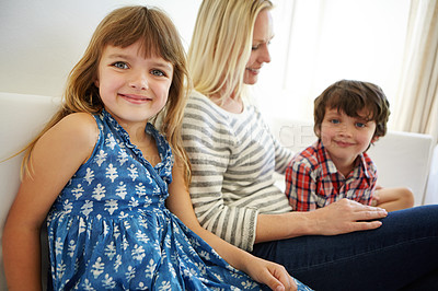 Buy stock photo Shot of a happy family spending quality time together at home on the sofa