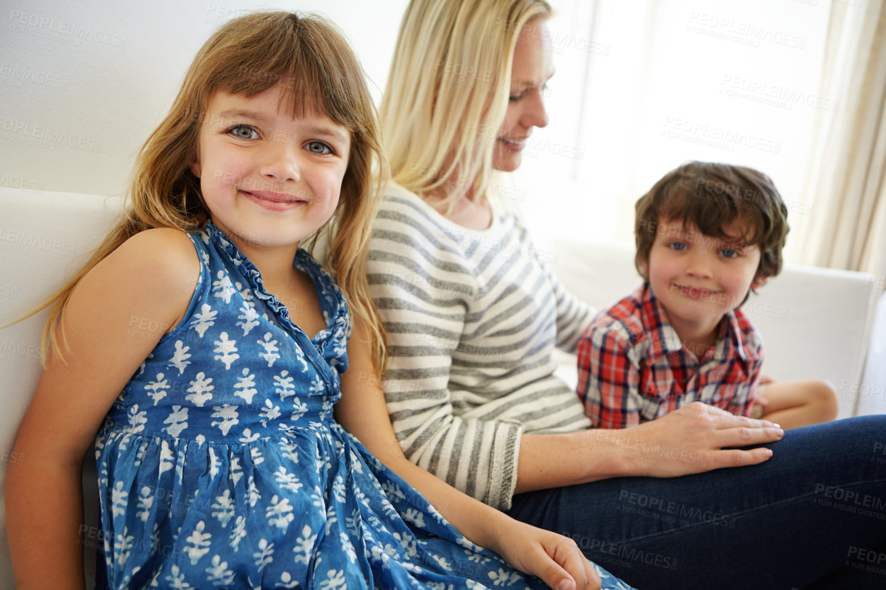 Buy stock photo Shot of a happy family spending quality time together at home on the sofa