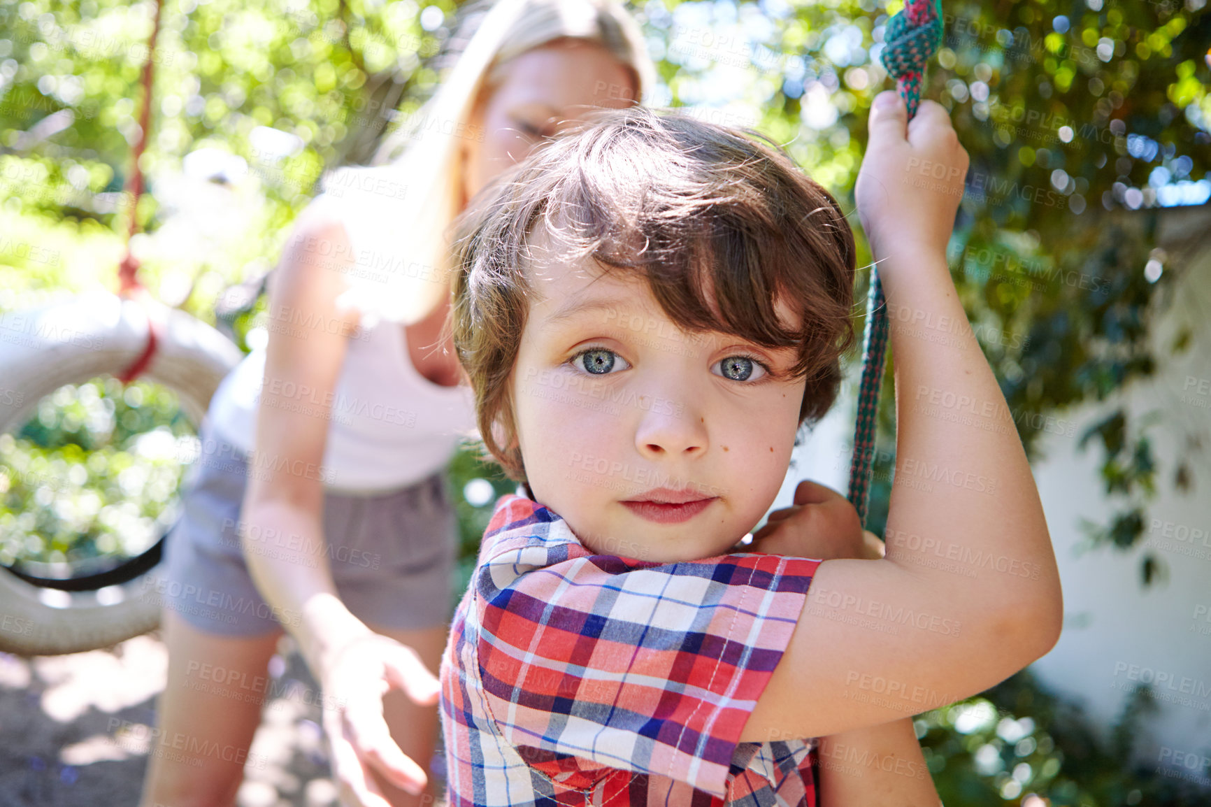 Buy stock photo Cropped shot of a young boy swinging in the yard