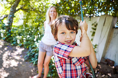 Buy stock photo Cropped shot of a young boy swinging in the yard