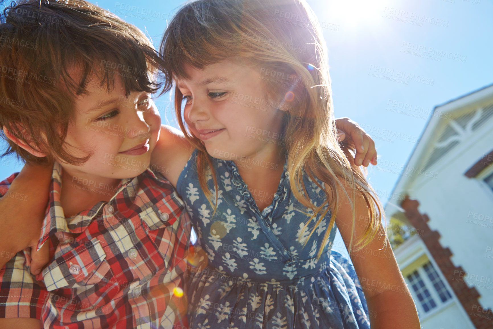 Buy stock photo Shot of an affectionate brother and sister embracing in their backyard