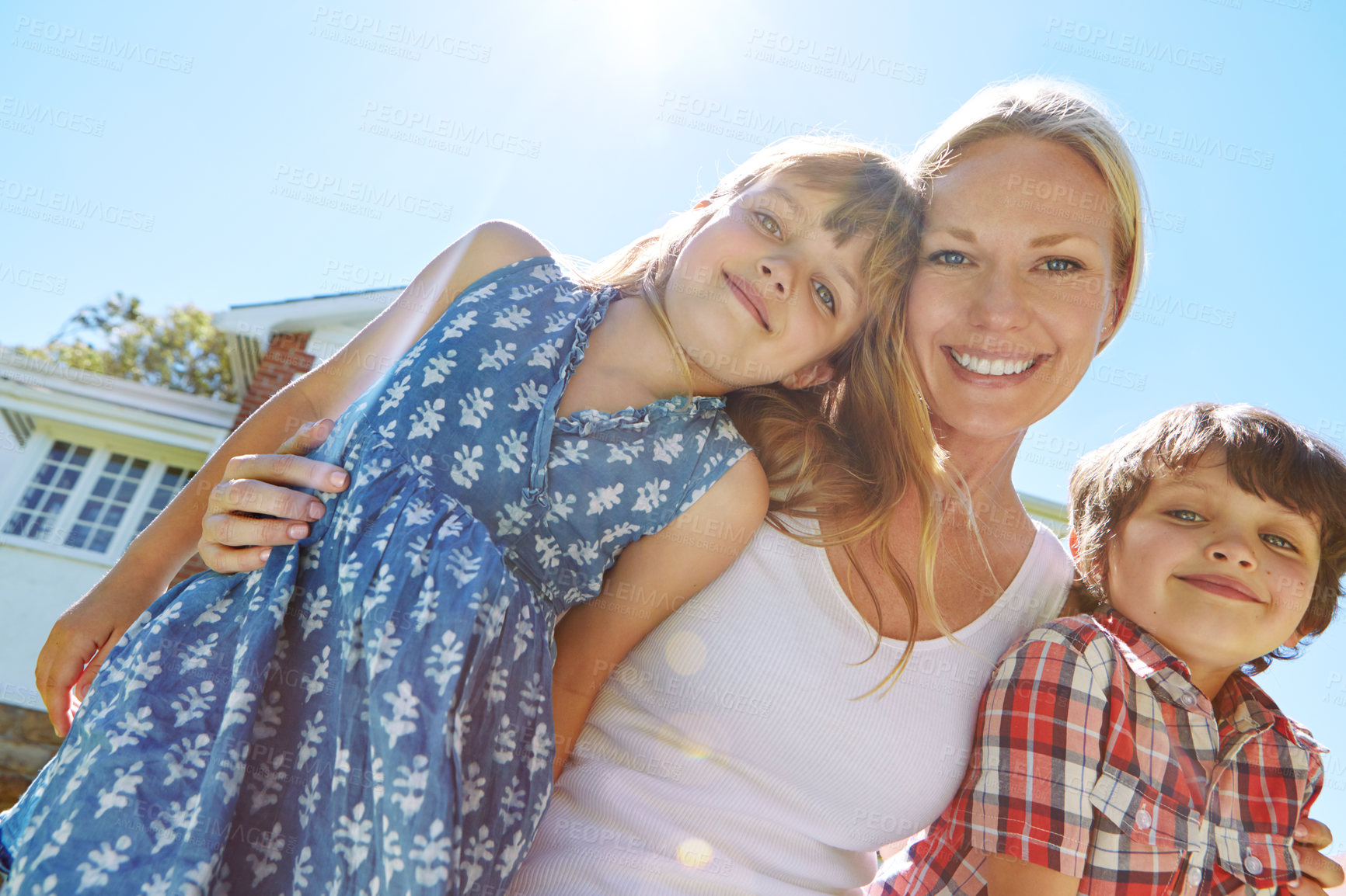 Buy stock photo Shot of a happy family of three enjoying a sunny day in their backyard