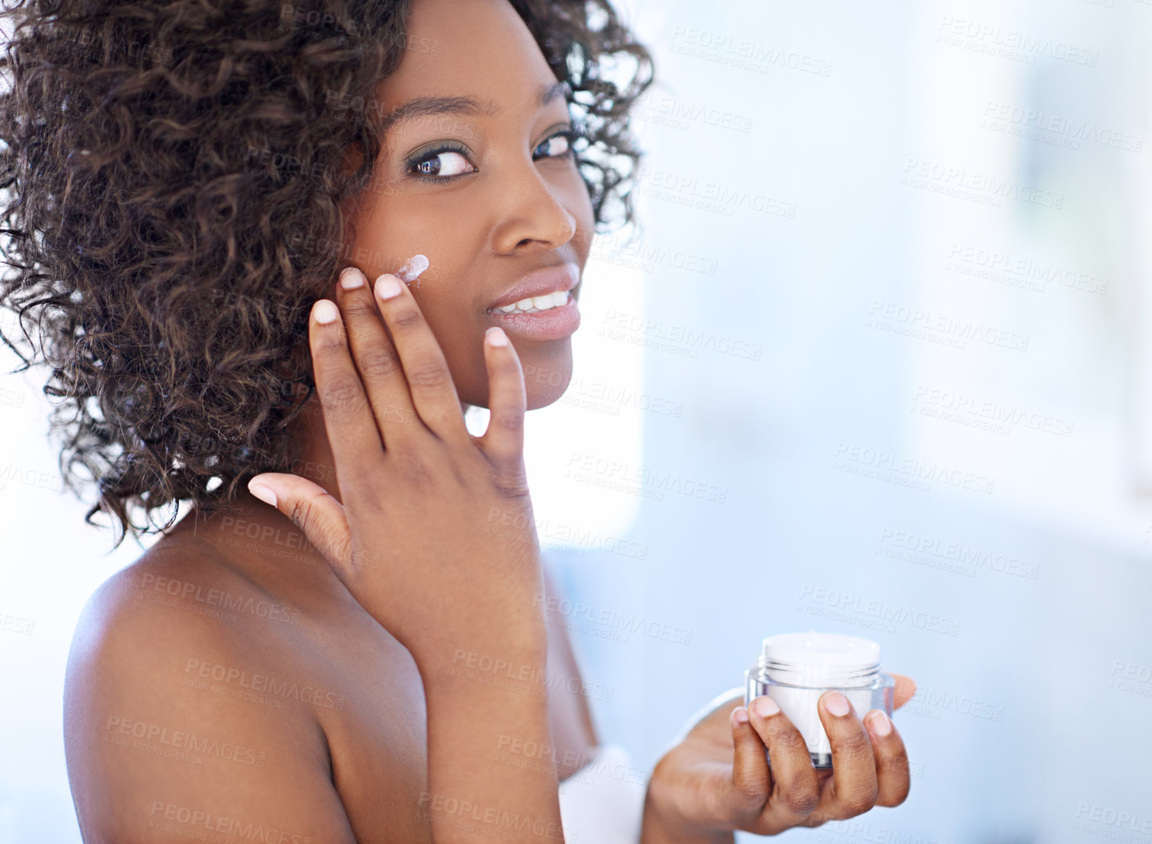 Buy stock photo Shot of a beautiful young woman during her daily beauty routine