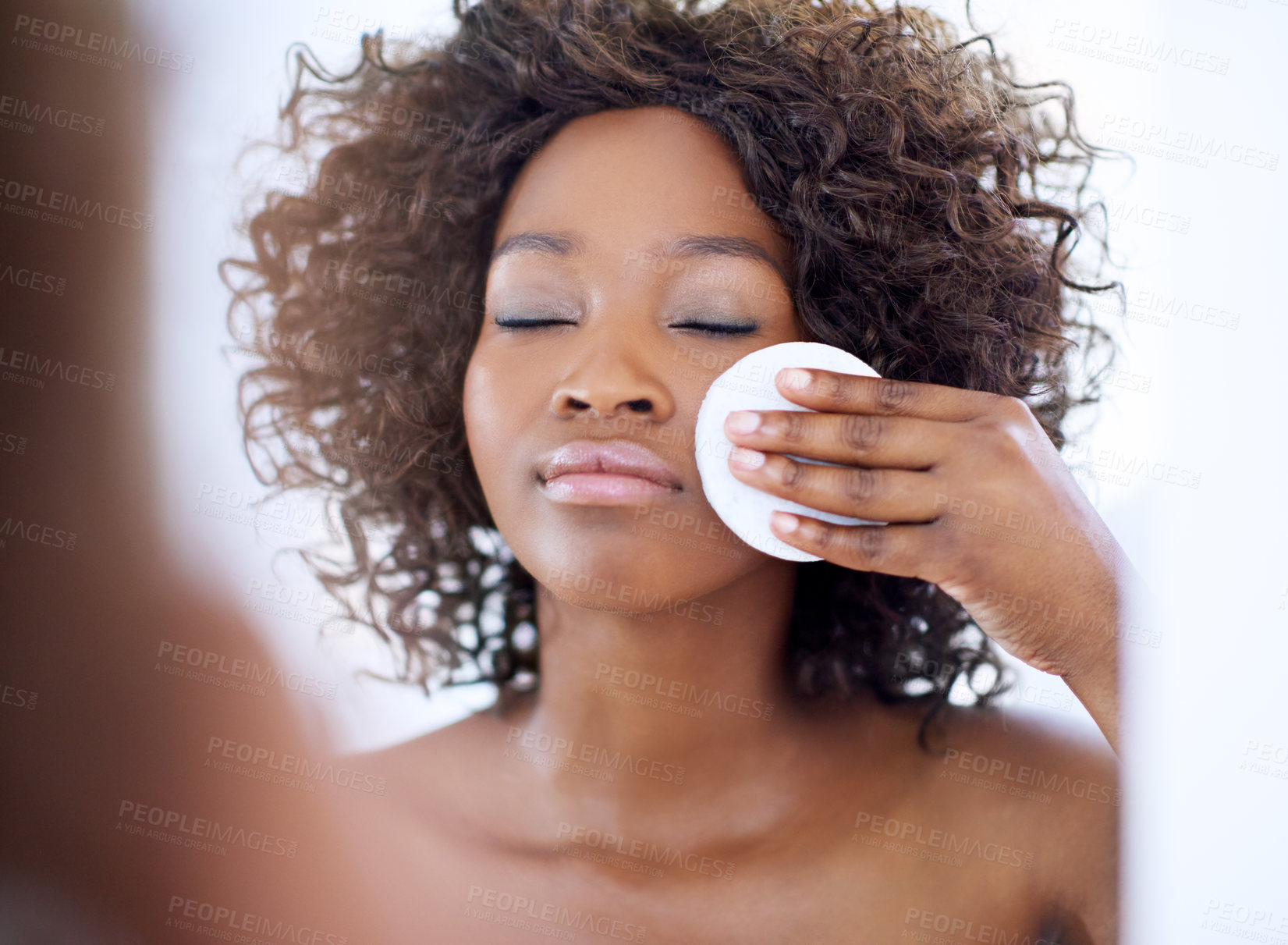 Buy stock photo Mirror, cotton pad and black woman for makeup, washing face and wellness for morning routine. Dermatology, skincare and person in bathroom for facial treatment, beauty and cosmetics for cleaning