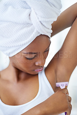 Buy stock photo Skincare, beauty and black woman shaving armpit in bathroom, getting ready and smooth skin with razor. Morning routine, hygiene and girl with underarm hair removal product, towel or cosmetics in home