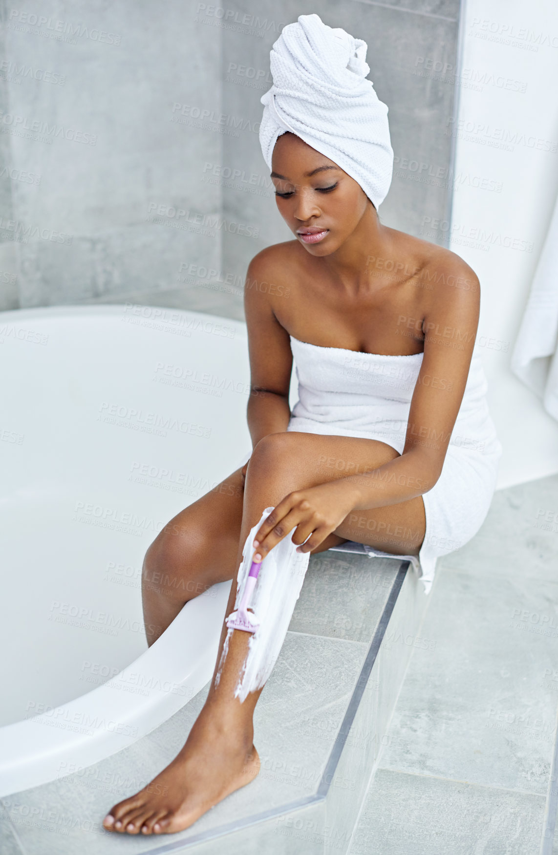 Buy stock photo Beauty, skincare and black woman shaving legs in bathroom with cream, razor or getting ready for smooth skin. Morning routine, hair removal and girl at bath with towel, cosmetics and grooming in home