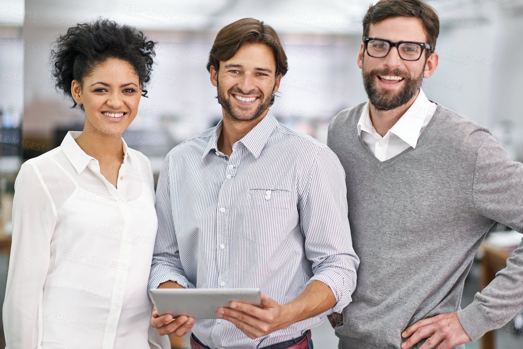 Buy stock photo Portrait of three young businesspeople standing in his office