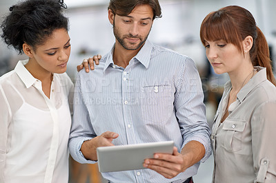 Buy stock photo Shot of three young business professionals having a meeting