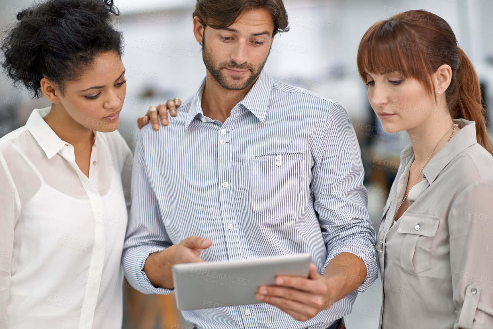 Buy stock photo Shot of three young business professionals having a meeting