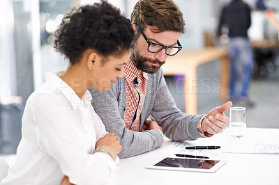 Buy stock photo Business people, tablet and collaboration in meeting for teamwork, planning or discussion on table at office. Businessman and woman with documents and technology for project or research at workplace