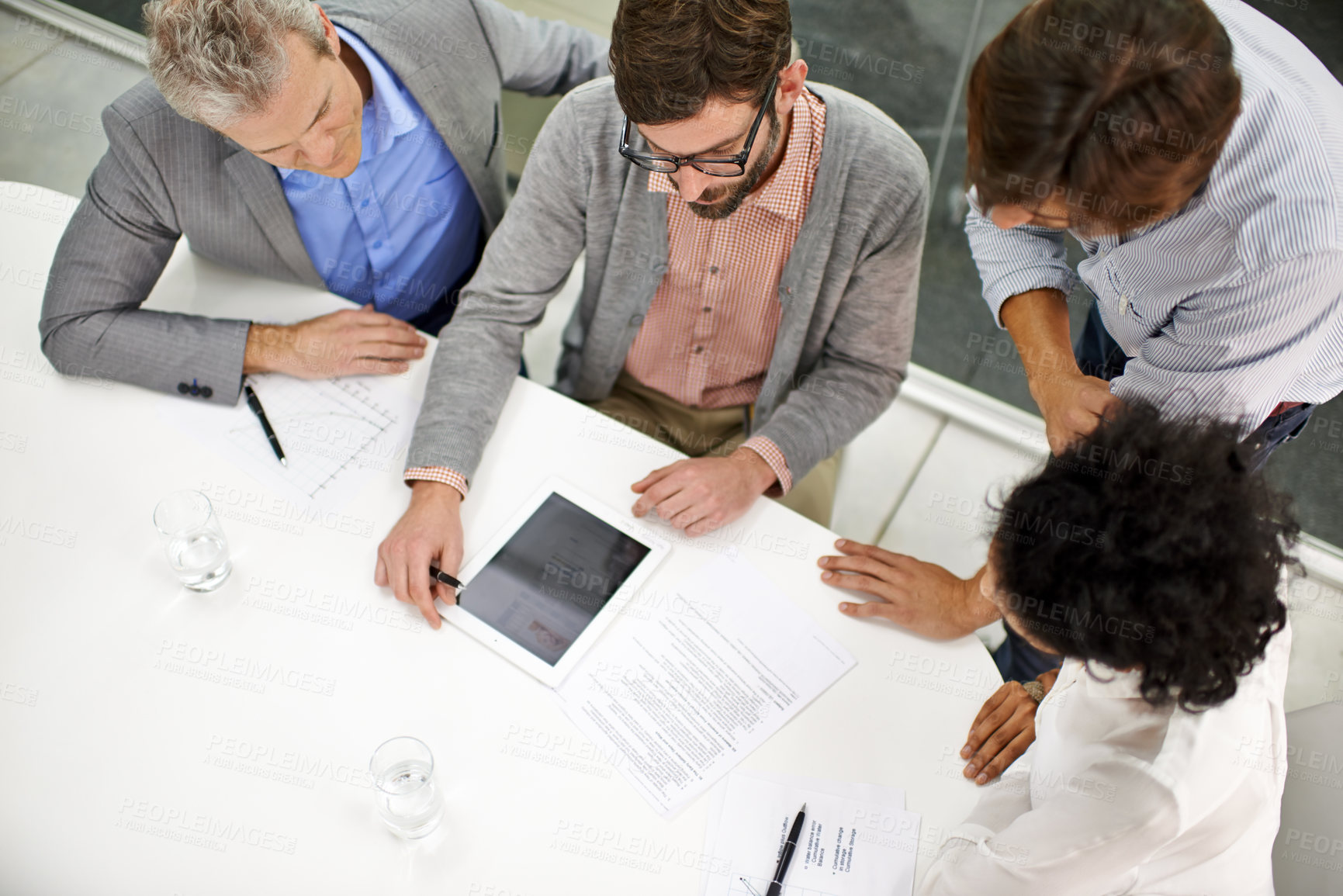 Buy stock photo Business people, meeting and tablet screen above in teamwork for planning, discussion or collaboration at office. Top view of group or employees with technology in project on mockup at workplace