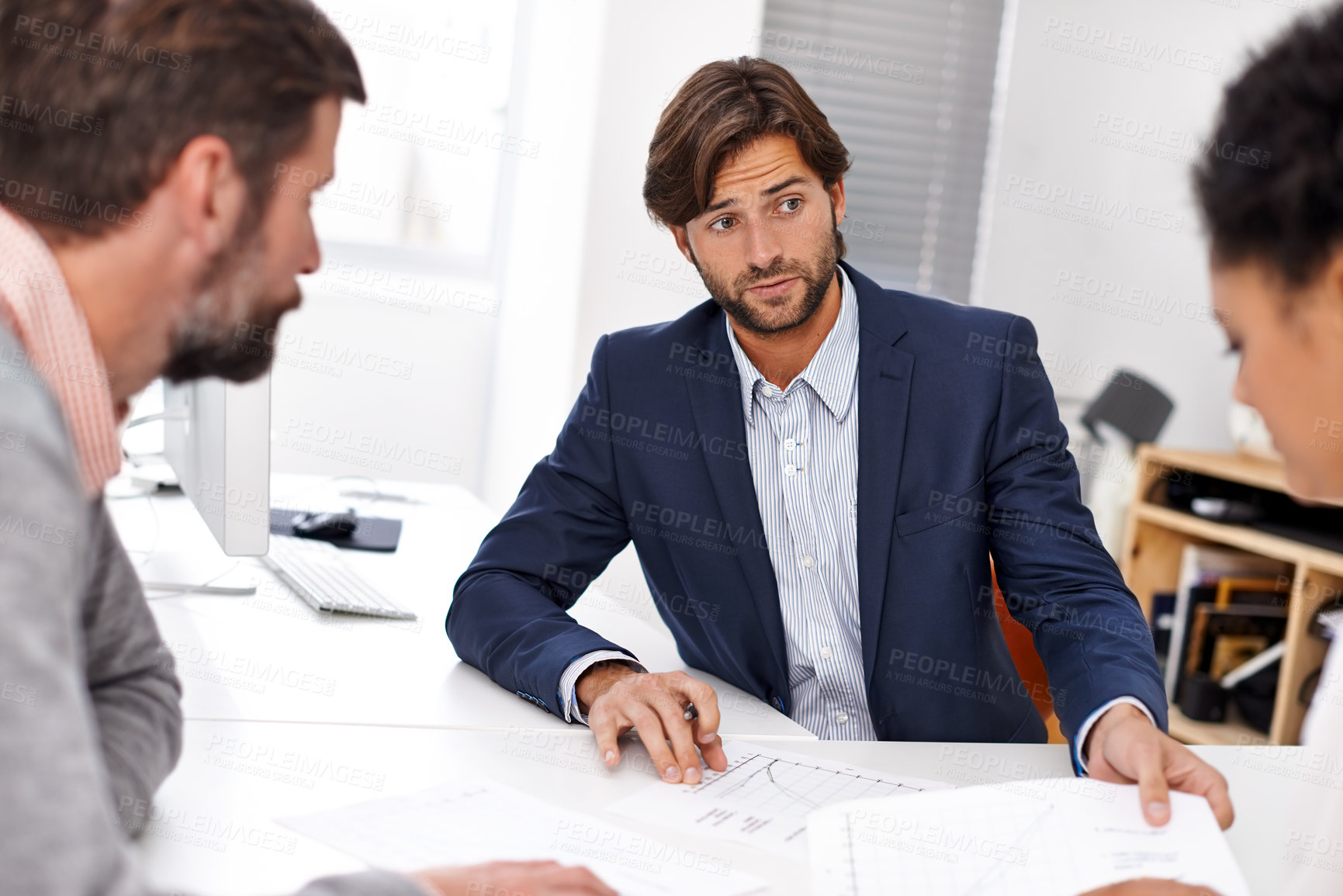 Buy stock photo Portrait of a group of young office professionals going over paperwork