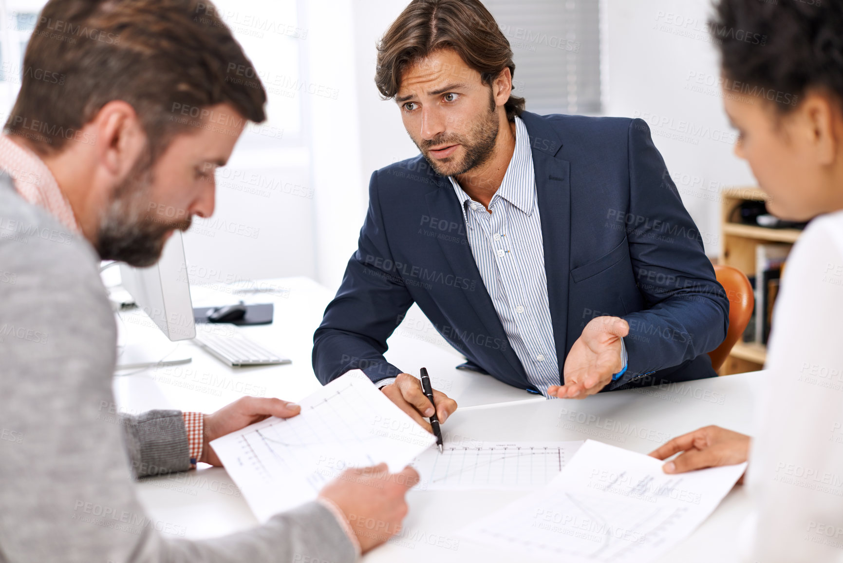 Buy stock photo Portrait of a group of young office professionals going over paperwork