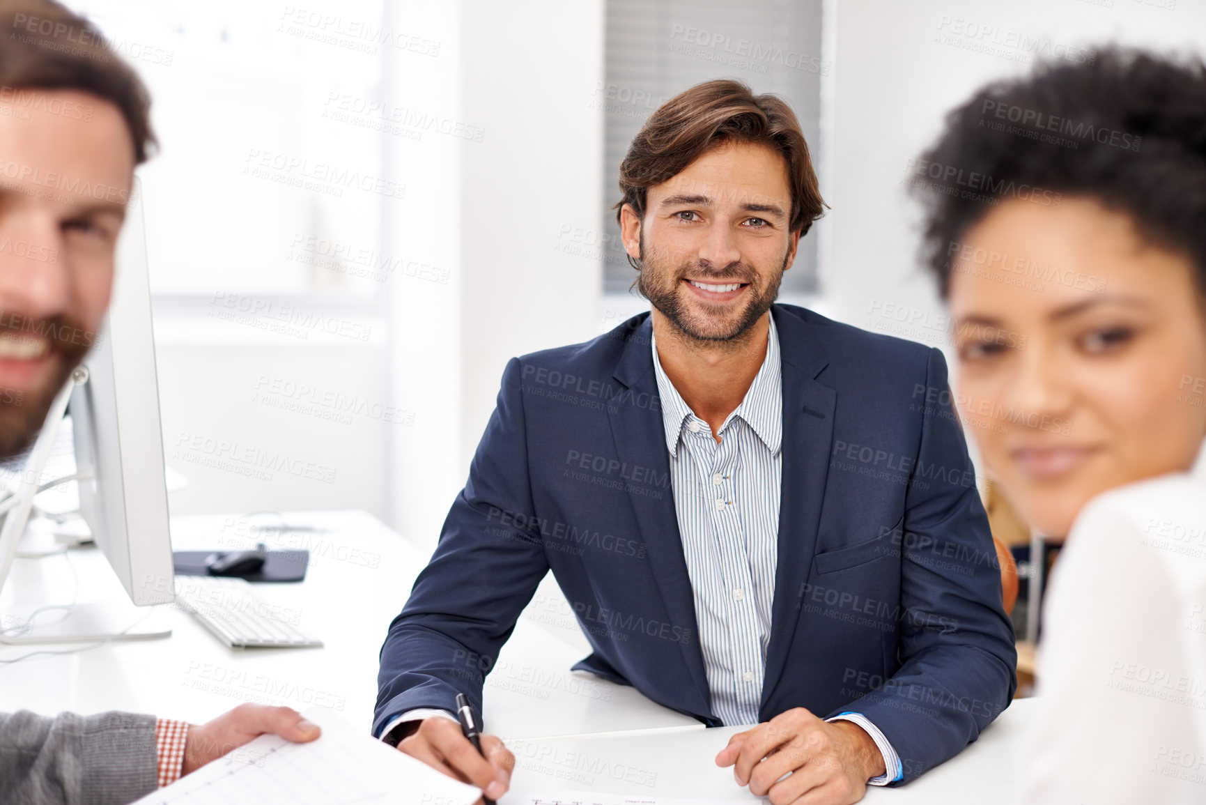 Buy stock photo Portrait of a group of young office professionals going over paperwork