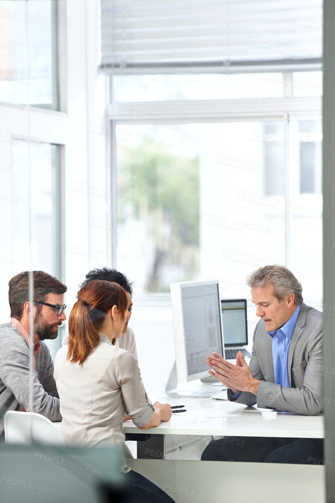 Buy stock photo A group of businesspeople going over some plans together