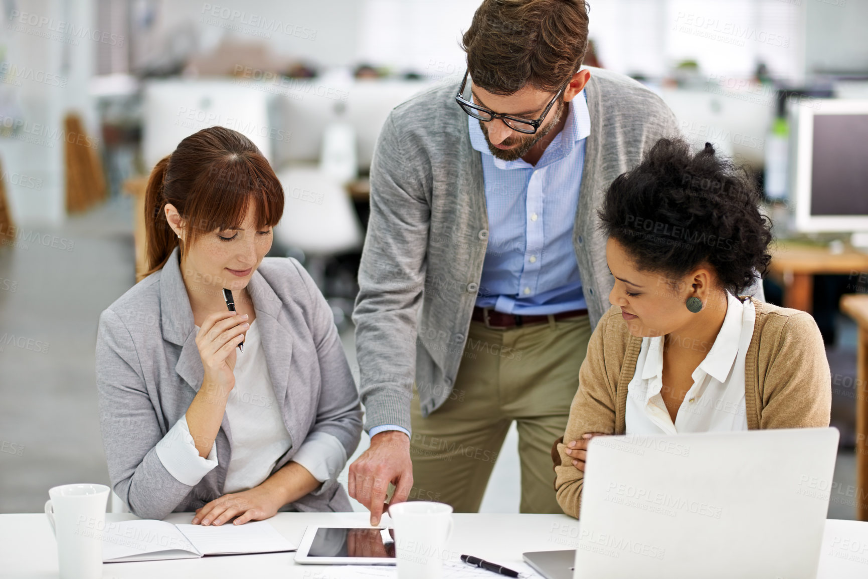 Buy stock photo Creative, teamwork and meeting or discussion with tablet in office for project planning and strategy review. Collaboration, employees and diversity with talking, startup and technology or listening