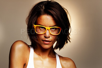 Buy stock photo Confident woman, messy hair or glasses in fashion, optometry or eyewear as edgy, trend or style. Assertive, female designer or specs in glow, prescription or apparel on studio on brown background