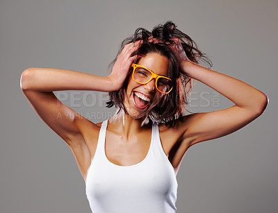 Buy stock photo Woman, music and fun with confidence, glasses and excited with smile and casual fashion in studio. Hair, portrait and happy with audio and wild hairstyle with grey background and freedom from party
