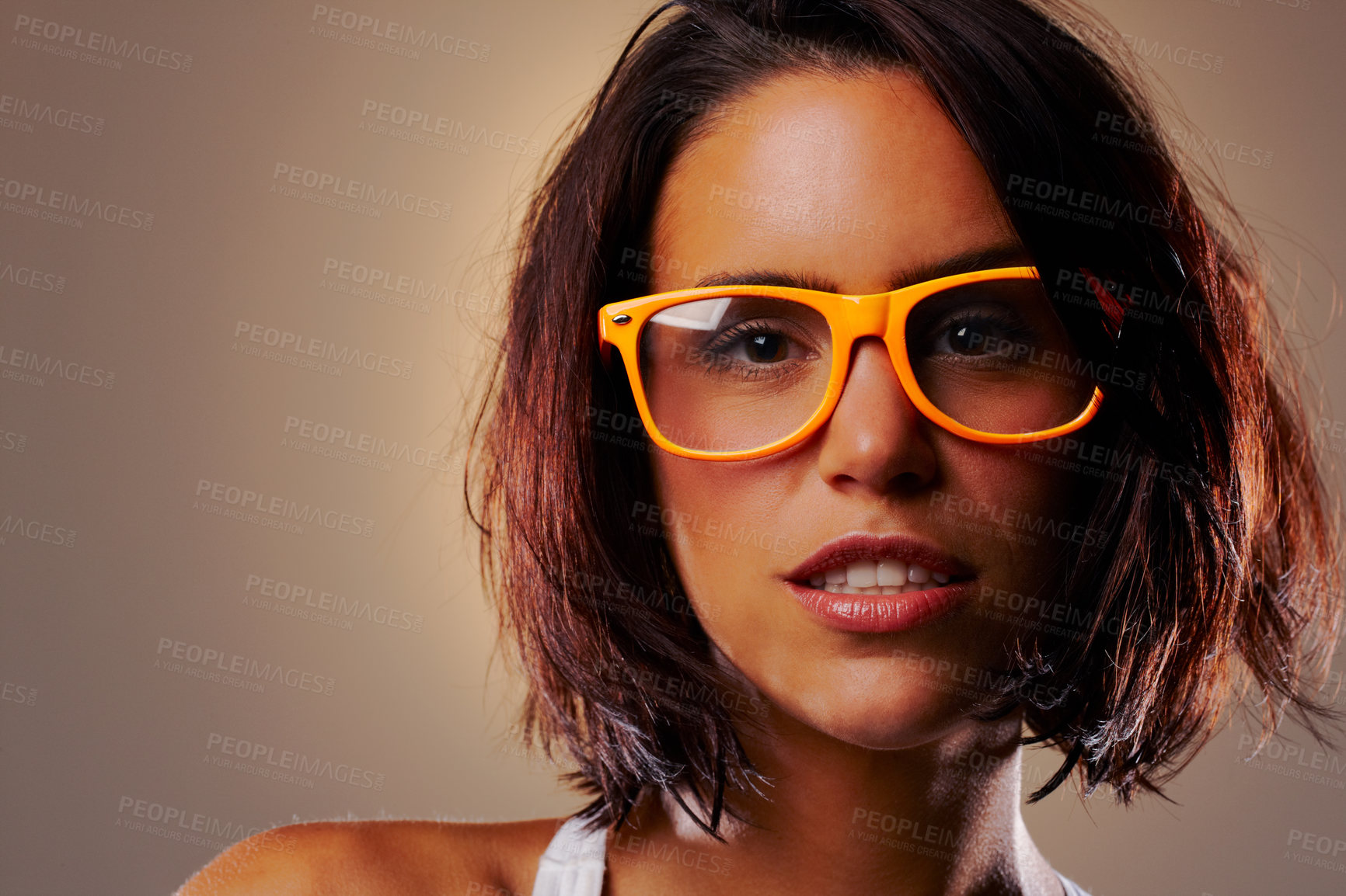 Buy stock photo Portrait, beauty and woman with glasses in studio for vision isolated on a brown background mockup space. Face, eyewear and fashion of young model in spectacles with makeup or cosmetics in Germany
