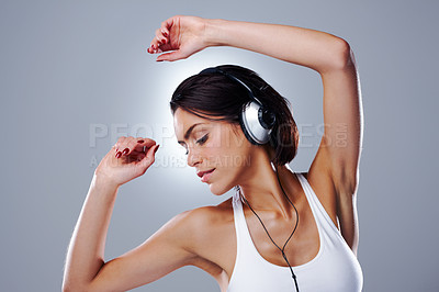 Buy stock photo Woman, music and dancing fun with headphones, relax and audio with song streaming and casual fashion in studio. Samba, style and dancer from Barcelona with joy and confidence with grey background