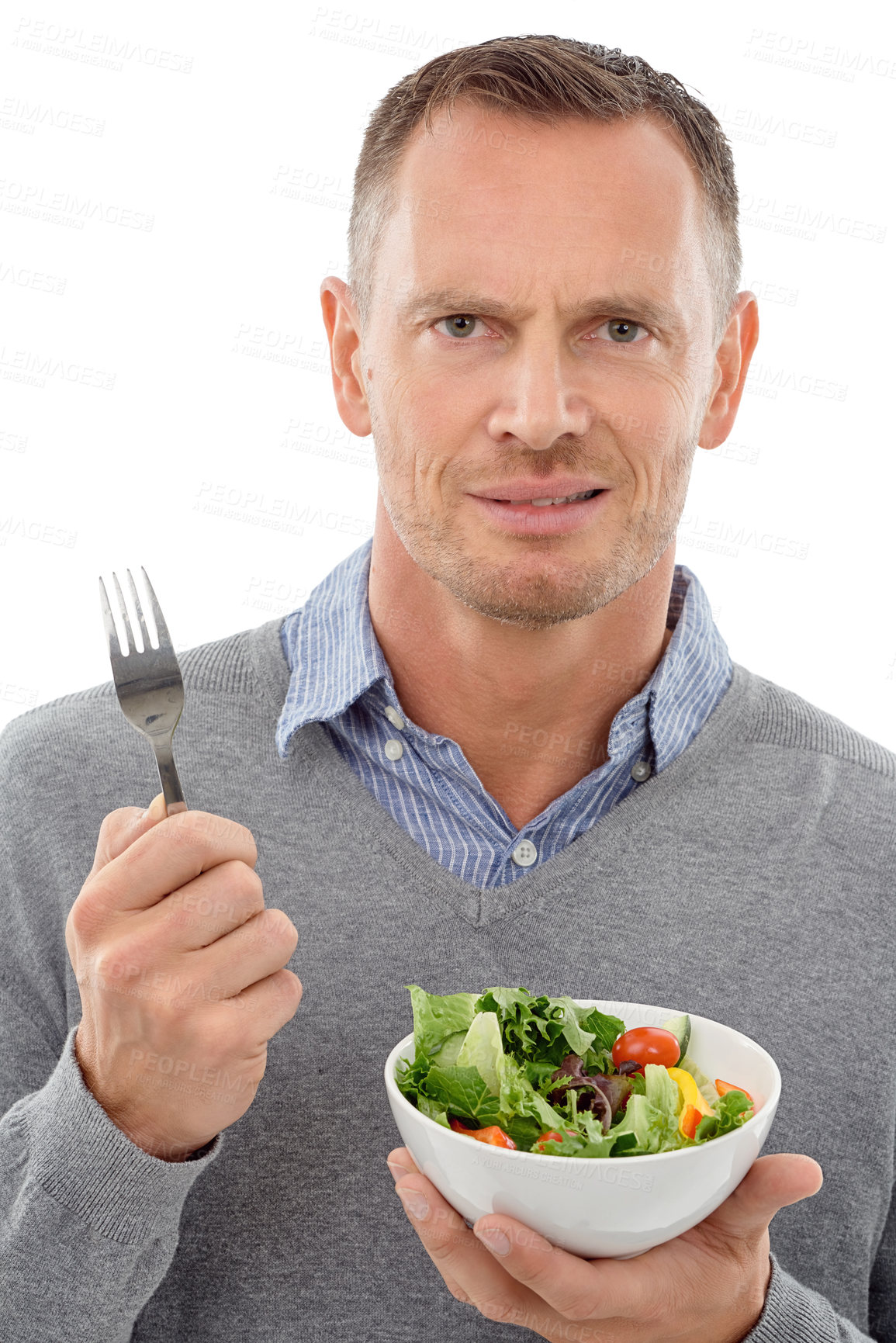 Buy stock photo Man, salad and vegetables studio portrait with disgust for healthy food with nutrition for health. Model person with vegan lunch or brunch bowl isolated on a white background with a fork for wellnes