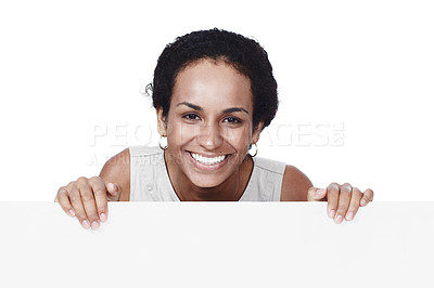 Buy stock photo Cropped studio portrait of a businesswoman standing behind a blank sign