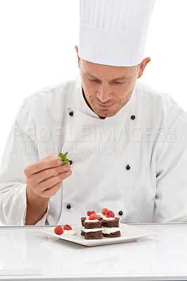 Buy stock photo Chef, presentation and mint on sweet cuisine by culinary cook with chocolate recipe on a plate isolated in white studio background. Cooking, food and man or person making mini cakes in a kitchen