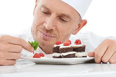 Buy stock photo Dessert, plate and chef in a studio cooking with mint for a sweet treat, snack or craving. Culinary, food industry and man baker baking a delicious cake with fruit while isolated by white background.