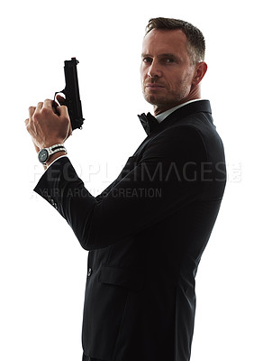 Buy stock photo Spy man, portrait and gun with suit for undercover mission, justice or espionage by white background. Government agent, detective and weapon in studio with designer tuxedo, secret information and job