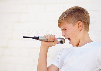 Buy stock photo Microphone, singer and voice of kid by wall for fantasy concert and art. Child on mic, karaoke and music, song and recording sound, audio performance of musician on technology and creative talent