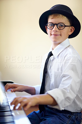 Buy stock photo Boy, piano and smiling as pianist, fun and confidence with attention, musician and enjoy. Portrait, creativity and passion with maestro, play and happiness for musical, child and practice keyboard
