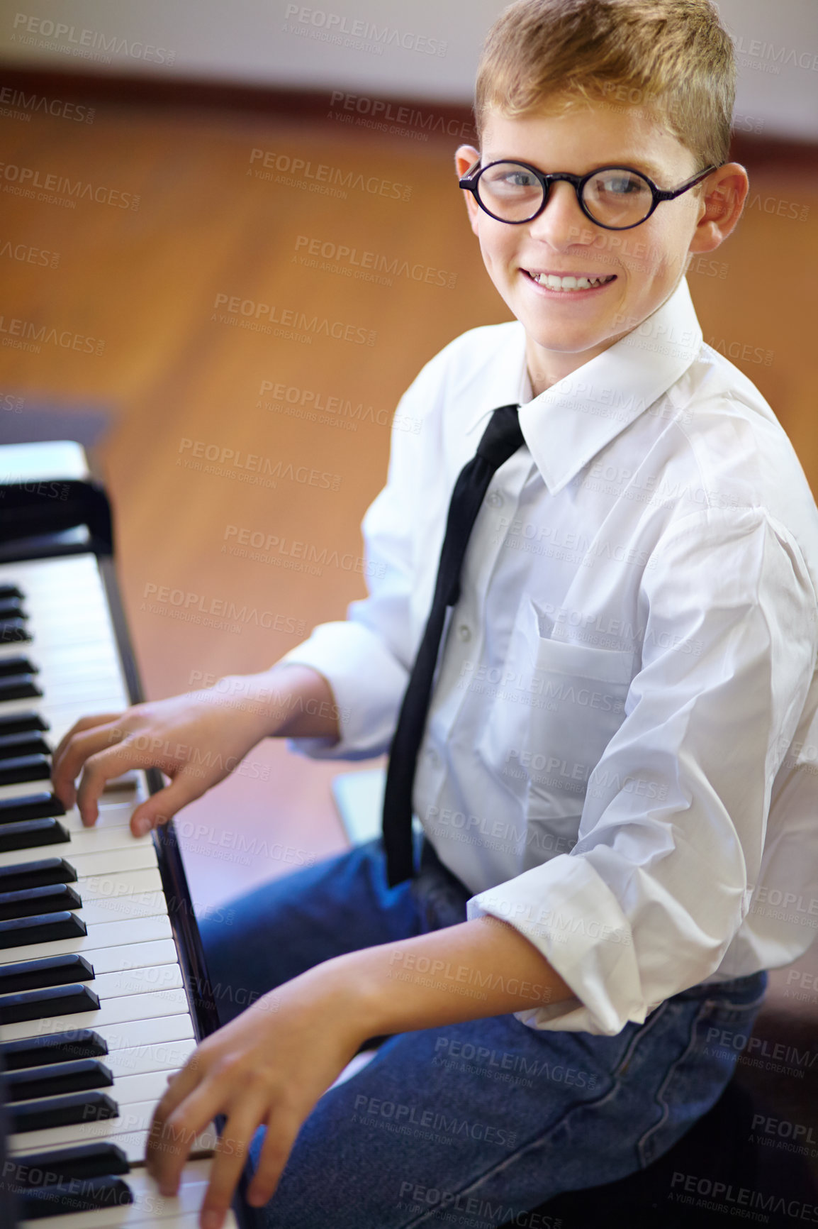 Buy stock photo Child, piano and smile as pianist, fun and confidence with learning, musician and enjoy. Portrait, creativity and happiness with maestro, playing and serious for musical, boy and practice keyboard
