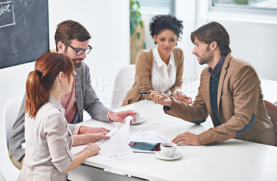 Buy stock photo A group of businesspeople going over some plans together