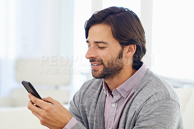 Buy stock photo Phone, smile and social media with business man in office for communication or networking. App, contact and information search with happy young employee reading or typing text message in workplace