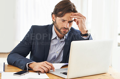 Buy stock photo A frustrated businessman working on his laptop