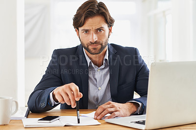 Buy stock photo A handsome businessman  appearing tense at his desk