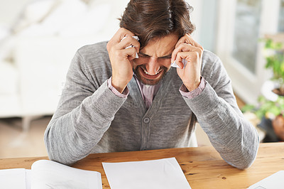 Buy stock photo A frustrated businessman with his head in his hands over work stress