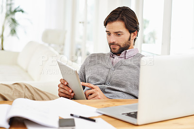 Buy stock photo Journalist, man and home with laptop on tablet for research, online and information for newspaper article. Freelancer, remote work and living room to write for publication with news and report 