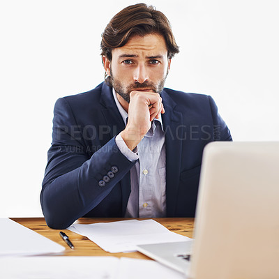 Buy stock photo Shot of a confident young businessman working on his laptop and looking at the camera