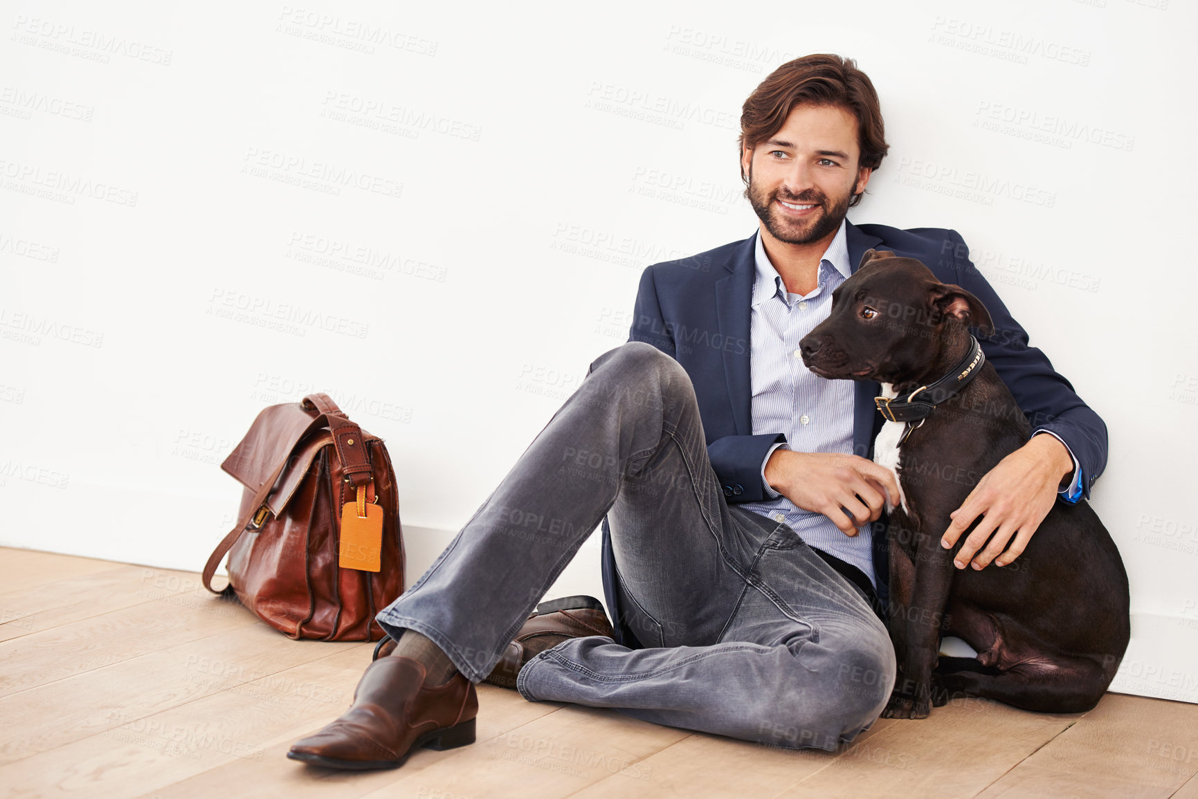 Buy stock photo A handsome businessman sitting alongside his dog