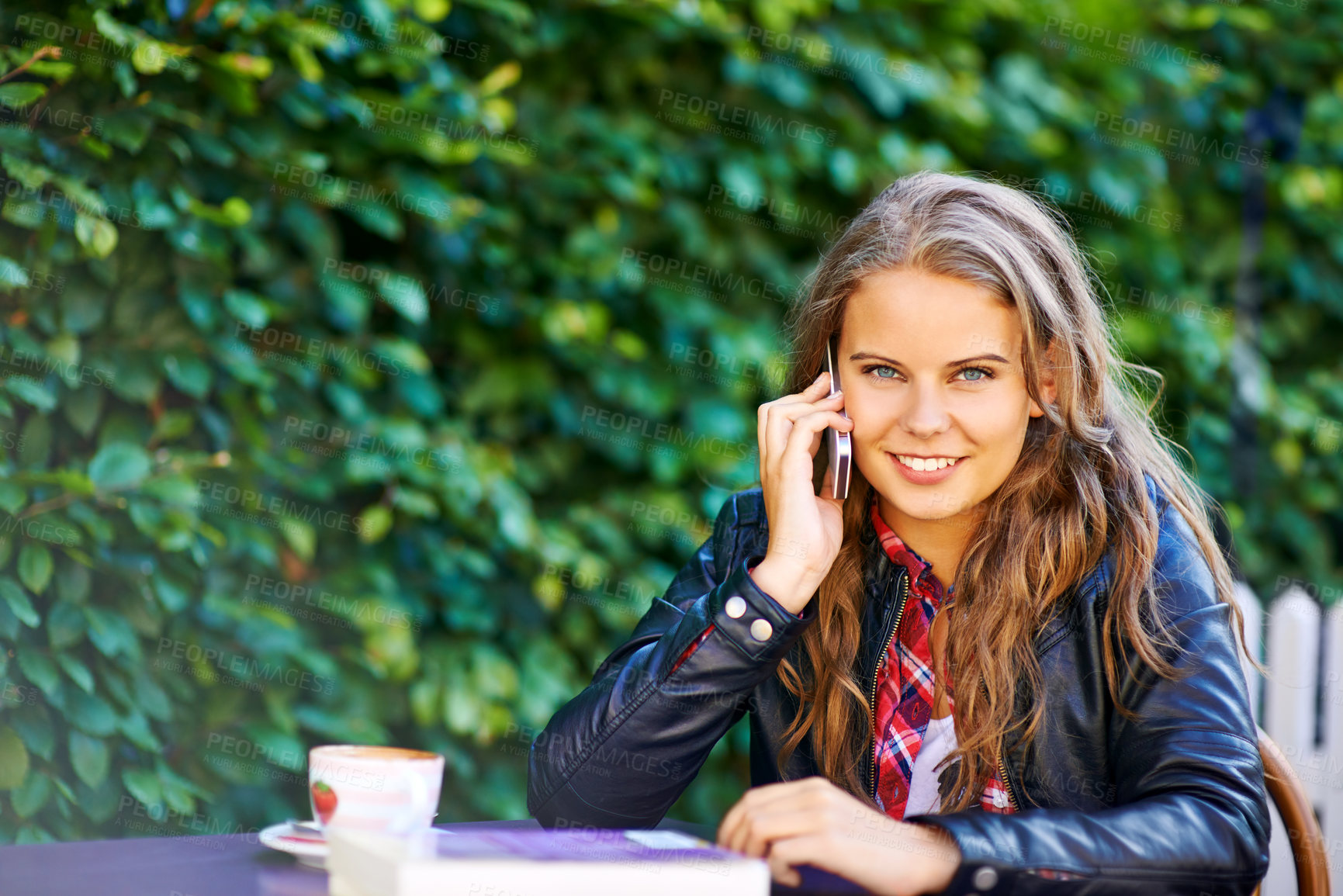Buy stock photo Portrait, happy woman and phone call by table, outdoors or cafe for communication. Young person, student and technology by mobile, conversation and talk with connectivity, cellular or network by web