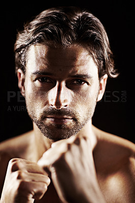 Buy stock photo Portrait, man and fist of serious boxer in studio isolated on a black background. Face, boxing and confidence of topless athlete ready for fight, exercise training or workout, sport or combat fitness