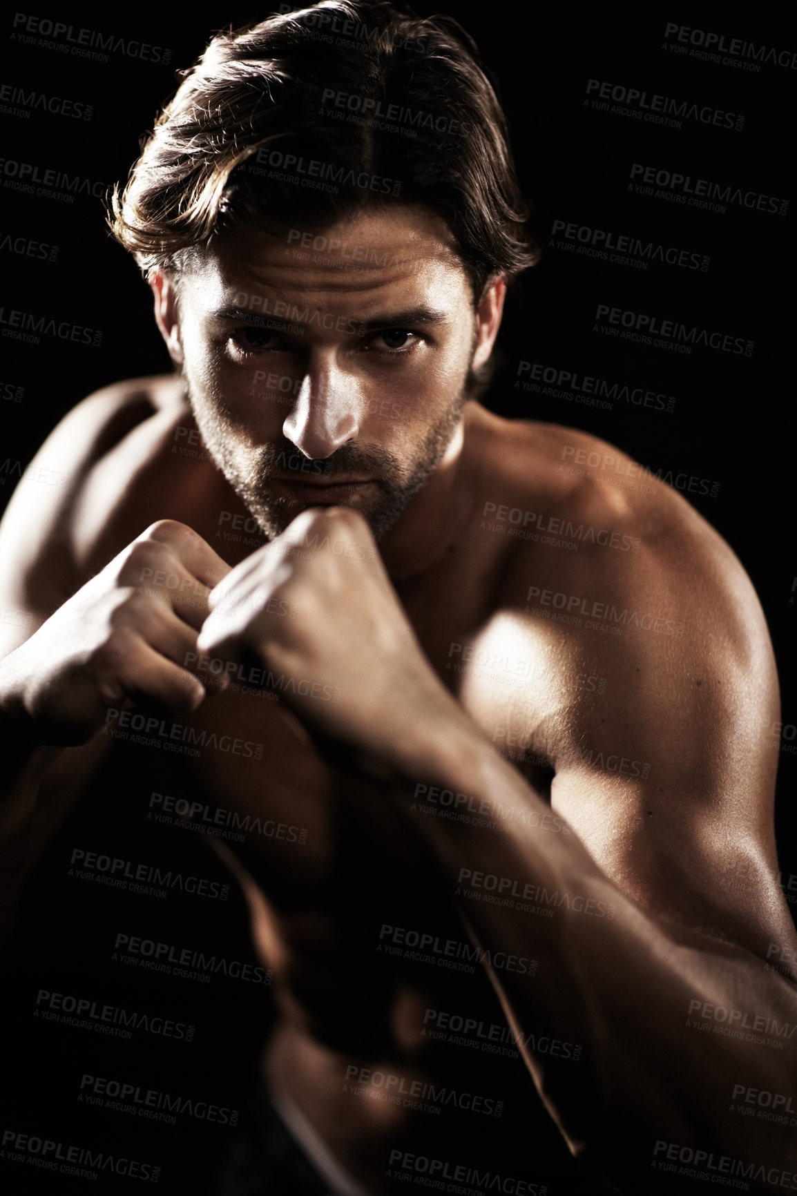 Buy stock photo Portrait, body of man and fist of boxer in studio isolated on black background. Serious face, boxing or muscle of topless athlete ready to fight, exercise or training, combat sport or fitness workout