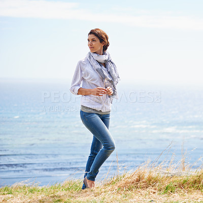 Buy stock photo Woman, thinking and walking in nature at the ocean with ideas for vacation, holiday mindfulness. Person, relax and remember a summer with freedom and peace on grass with blue sky, sea and environment