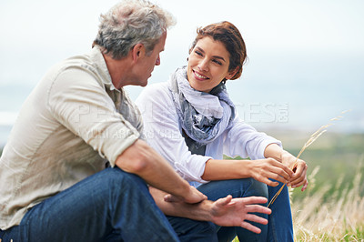 Buy stock photo Couple, face and smile outdoor with relax, communication and peace for bonding, relationship or holiday. Mature, man and woman with happy, sitting and break in nature with travel, vacation and trust