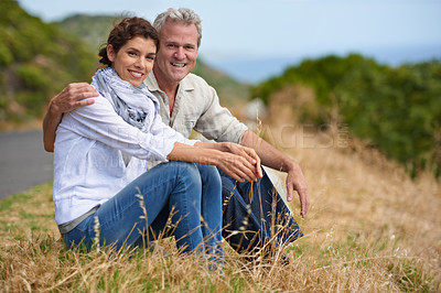 Buy stock photo Couple, face and happy in nature with relax, communication and peace for bonding, relationship or roadtrip. Mature, man and woman with smile, sitting and break outdoor with travel, vacation and trust
