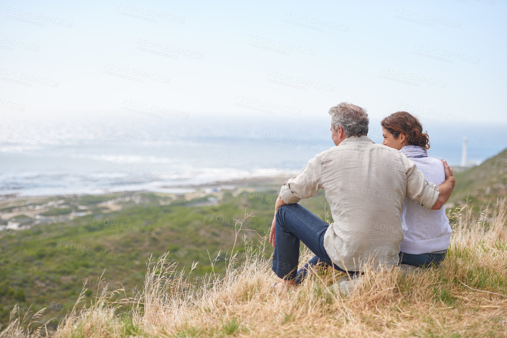 Buy stock photo Old couple, hug and sitting on a mountain with love in marriage, retirement or holiday mockup space. Summer, vacation and man and woman embrace with support, care or trust with view of sea or ocean