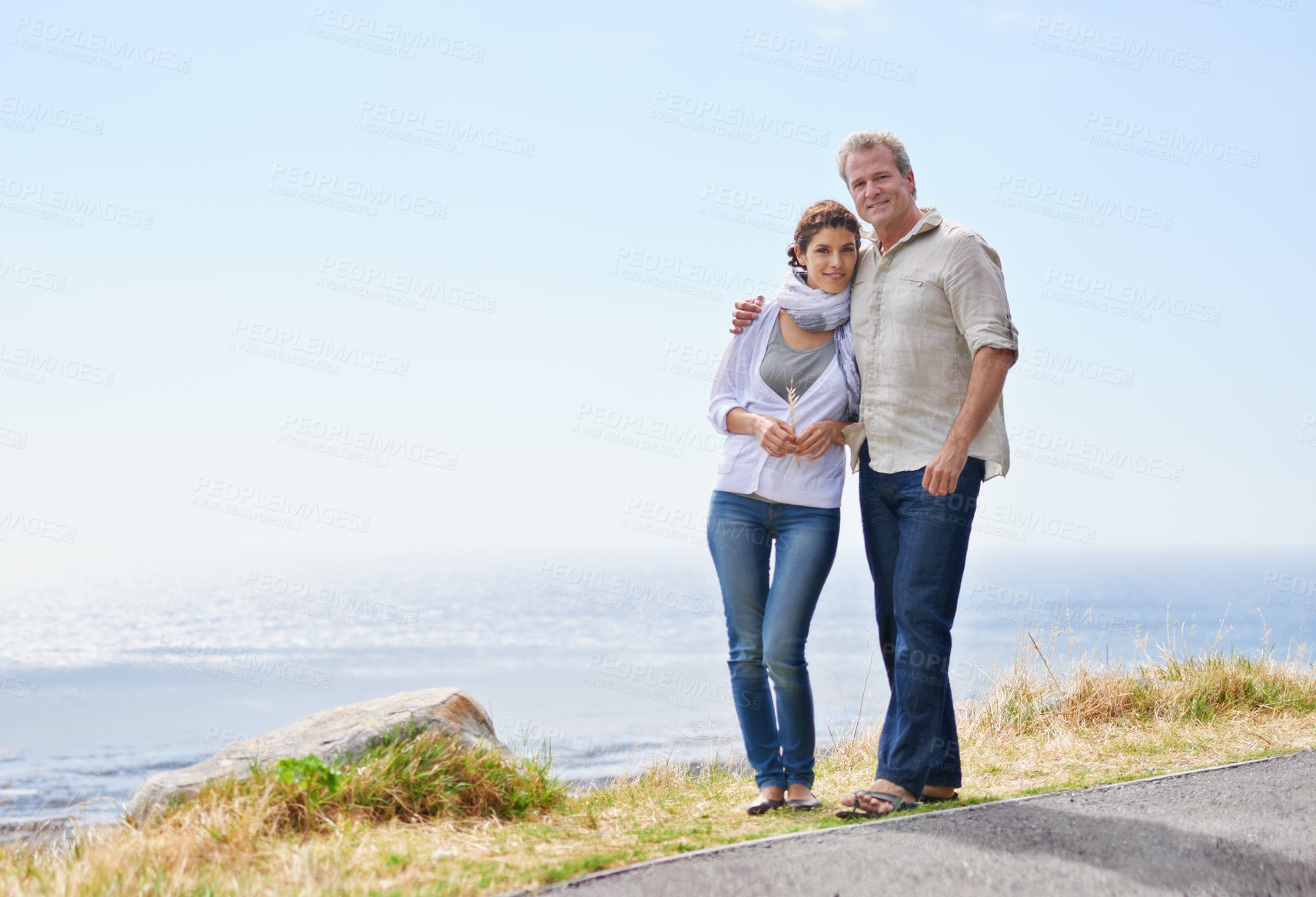 Buy stock photo Mature couple, hug and portrait at the sea, ocean or walk on road at the beach in retirement mockup. Summer, vacation or holiday with old man and woman together with love and support in marriage