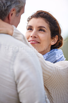 Buy stock photo Couple, outdoor and smile with love at beach with kindness, support and care in marriage. Happy, woman and gratitude for partner on holiday, date or relax on vacation together in calm morning