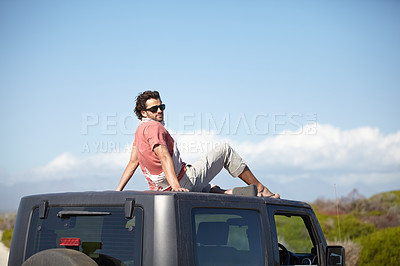 Buy stock photo Road trip, man and roof of car for view, scenery, nature and fresh air on adventure or vacation in Africa. Person, tourist or traveler on rooftop with sunglasses and sky mockup for peace or journey